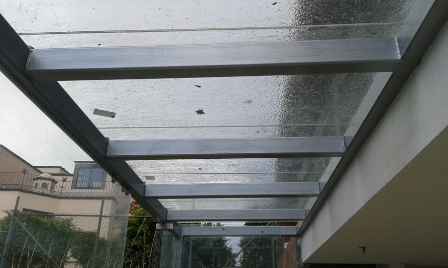 Fabricación y colocación de estructura metálica y vidrio templado acceso oficinas corporativas