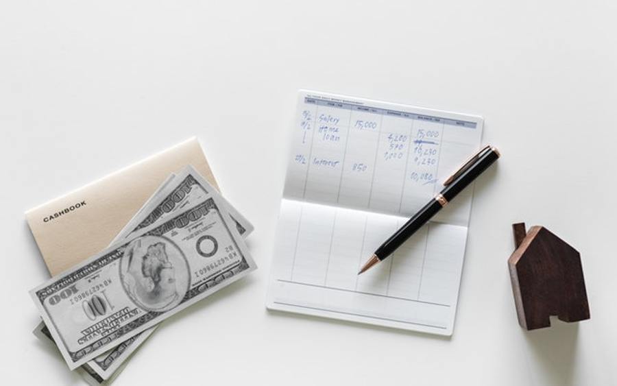 Dinero, anotador con cuentas, lapicera